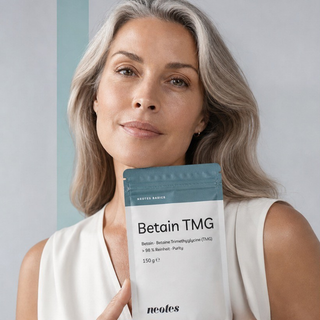 Woman holding a pouch of neotes betaine TMG powder in a calm lifestyle scene