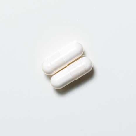 White vegan neotes betaine TMG capsules in close-up on a light background