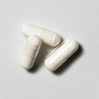 White vegan neotes creatine capsules in close-up on a light background