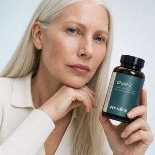 Mature woman with a neotes jar of GlyNAC capsules in a calm lifestyle scene