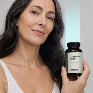 Woman holding a jar of neotes magnesium citrate capsules in a calm lifestyle scene