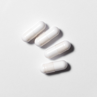 White neotes magnesium citrate capsules in close-up on a light background