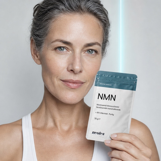 Woman holding a pouch of neotes NMN powder in a bright lifestyle scene