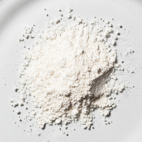 White NMN powder in close-up on a light background