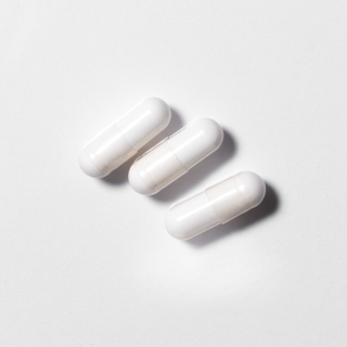 White vegan neotes NMN capsules in close-up on a light background