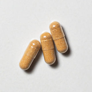 Brown vegan neotes sulforaphane capsules in close-up on a light background