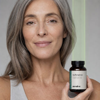 Mature woman holding a neotes jar of sulforaphane capsules in a lifestyle scene