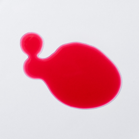 Red vitamin B12 drops as a liquid in a bright close-up